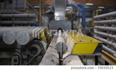 Aluminium extrusion production line factory. Production of Complex lightweight extruded aluminium metal profiles, commonly used as material in construction and manufacturing Aluminium extrusion production line factory. Production of Complex lightweight extruded aluminium metal profiles, commonly used as material in construction and manufacturing 70039523