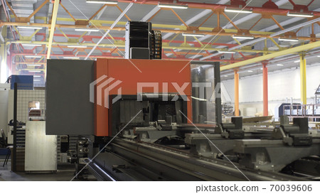Drilling aluminium profile at workshop. Modern tool in heavy industry. High precision manufacture of aluminium parts. Automation of process indoors. Automatic work for ironwork. Robotic computer cnc Drilling aluminium profile at workshop. Modern tool in heavy industry. High precision manufacture of aluminium parts. Automation of process indoors. Automatic work for ironwork. Robotic computer cnc 70039606