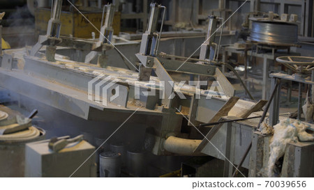 Forming aluminum column after melting in modern factory. Production of aluminium metal profiles, commonly used as material in construction and manufacturing. Forming aluminum column after melting in modern factory. Production of aluminium metal profiles, commonly used as material in construction and manufacturing. 70039656