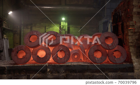 Red hot metal workpieces in foundry. Room for manufacture of metal products by casting. Casting shop for gassified models. Blast Furnace Steel Production Steel Works. Red hot metal workpieces in foundry. Room for manufacture of metal products by casting. Casting shop for gassified models. Blast Furnace Steel Production Steel Works. 70039796