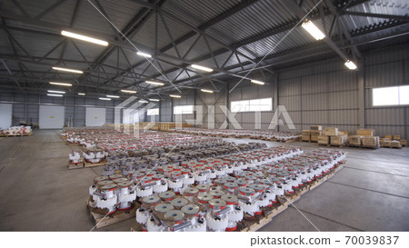 Oil and Gas Wellhead tree equipment production plant in warehouse. Parts of wellhead fittings and butterfly valves. Equipment for wellhead conncetion of oil and gas wells in warehouse. Oil and Gas Wellhead tree equipment production plant in warehouse. Parts of wellhead fittings and butterfly valves. Equipment for wellhead conncetion of oil and gas wells in warehouse. 70039837