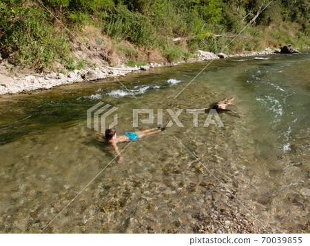 Happy teens having fun swimming in the river water Happy teens having fun swimming in the river water 70039855