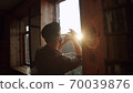 Russia, Moscow - Man at home in quarantine plays music from the windows - flash mob during pandemic of n-cov19 Coronavirus 70039876