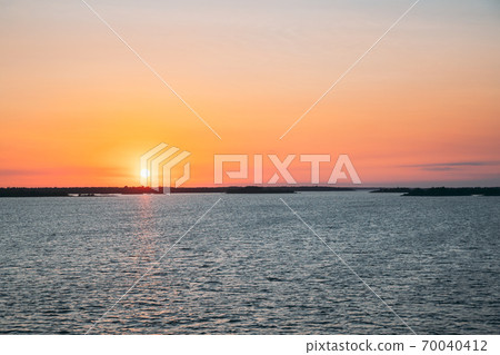 Sweden. Beautiful Seascape In Sunset Sunrise Time. Sun Sunshine Above Rocky Islands Archipelago. Sunny Summer Evening Sweden. Beautiful Seascape In Sunset Sunrise Time. Sun Sunshine Above Rocky Islands Archipelago. Sunny Summer Evening 70040412
