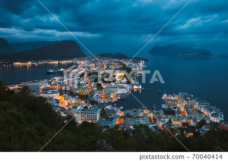 Alesund, Norway. Night View Of Alesund Skyline Cityscape. Historical Center In Summer Evening. Famous Norwegian Landmark And Popular Destination. Alesund, Kiven viewpoint, Mt Alesund, Norway. Night View Of Alesund Skyline Cityscape. Historical Center In Summer Evening. Famous Norwegian Landmark And Popular Destination. Alesund, Kiven viewpoint, Mt 70040414