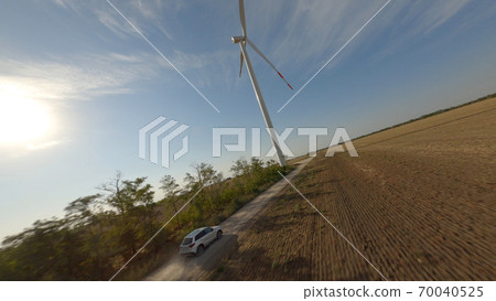 Wind turbine in countryside field 70040525