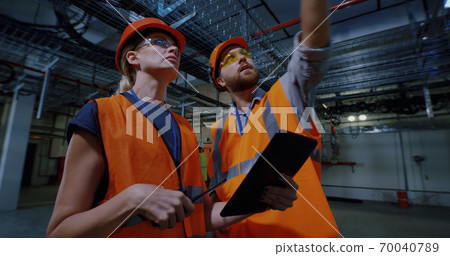 Engineer showing workshop to inspector 70040789