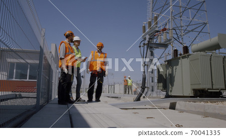 Builders discussing power plant construction Builders discussing power plant construction 70041335