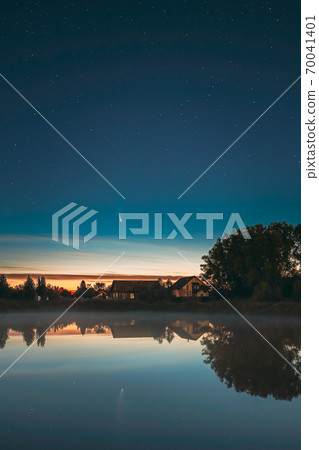 Dobrush, Belarus. Comet Neowise C2020f3 In Night Starry Sky Reflected In Small Lake Waters. 70041401