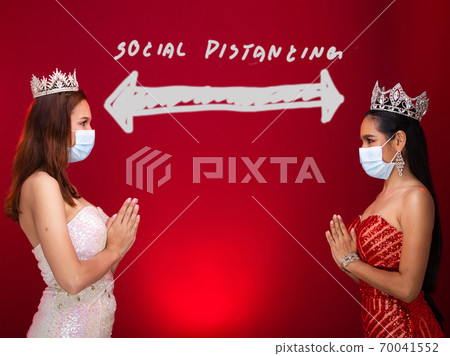 Two Miss Beauty Queen Pageant Contest apply New Normal to contestants by wearing Protective Face Mask, Diamond Crown. Concept Greeting Social Distancing, no contact, Red Tone Background copy space Two Miss Beauty Queen Pageant Contest apply New Normal to contestants by wearing Protective Face Mask, Diamond Crown. Concept Greeting Social Distancing, no contact, Red Tone Background copy space 70041552