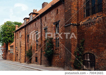 Old brick buildings in street in Wismar 70041681