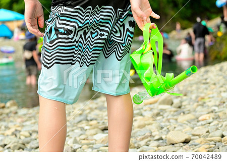 Elementary school boys playing in the river 70042489