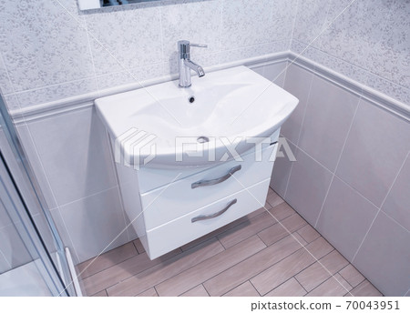Sale of a new and modern designer hand washbasin with drawers in the bathroom. Background, bathroom furniture Sale of a new and modern designer hand washbasin with drawers in the bathroom. Background, bathroom furniture 70043951