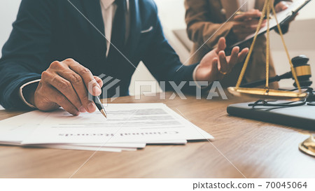 Judge gavel with Justice lawyers having team meeting at law firm background. Concepts of Law and Legal services. Judge gavel with Justice lawyers having team meeting at law firm background. Concepts of Law and Legal services. 70045064