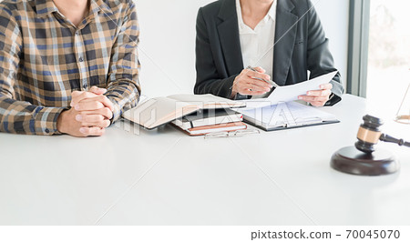 Judge gavel with Justice lawyers having team meeting at law firm background. Concepts of Law and Legal services. Judge gavel with Justice lawyers having team meeting at law firm background. Concepts of Law and Legal services. 70045070