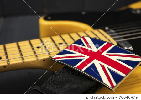 Brooch of the British Union Jack flag on the strap of an American classic electric guitar 70046479