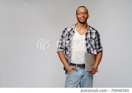 A young african american man working with a laptop pc 70046560