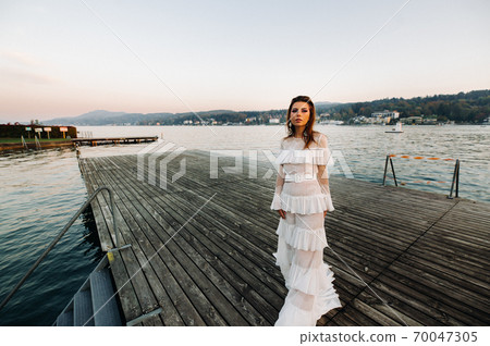 Bride in white wedding dress in the old town of Velden am w rthersee.Model in a wedding dress in Austria.Alps 70047305