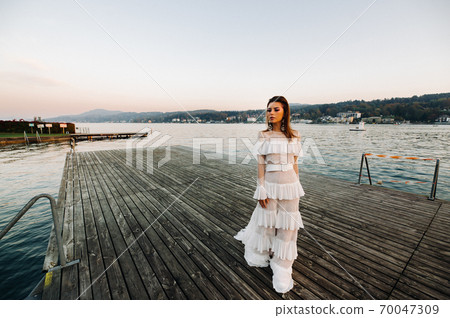 Bride in white wedding dress in the old town of Velden am w rthersee.Model in a wedding dress in Austria.Alps 70047309