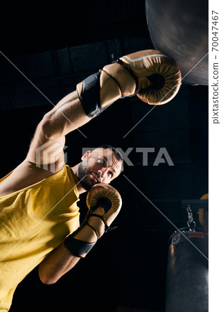Fighter hitting a boxing bag with a left hook 70047467