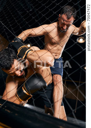 Brutal boxer is striking his scared opponent 70047472