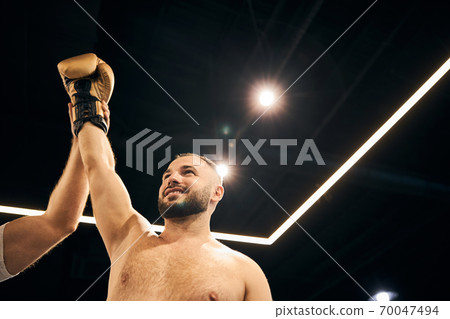 Cheerful winner expressing joy after a fight 70047494