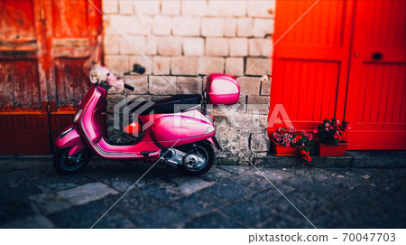 Pink girl italian moped with red helmet in summer Sorrento 70047703