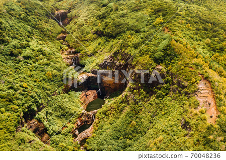 Aerial top view perspective of Tamarin Waterfall Seven Cascades in the tropical island jungle of Mauritius. 70048236