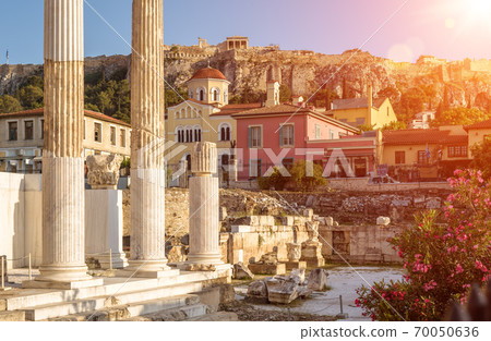 Hadrian`s Library overlooking famous Acropolis at sunset, Athens, Greece. Sunny view of Ancient Greek ruins at Plaka district. 70050636