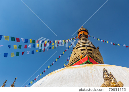 Tower of the Boudhanath Stupa decorated with flags in Kathmandu, Nepal. 70051553