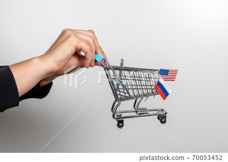 Shopping carts, United States and Russian flags. Trade agreement and policy Shopping carts, United States and Russian flags. Trade agreement and policy 70053452