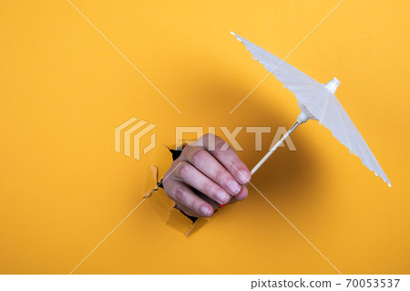 Parasol in a woman's hand. recreation, travel, entertainment and the sea or ocean concept Parasol in a woman's hand. recreation, travel, entertainment and the sea or ocean concept 70053537