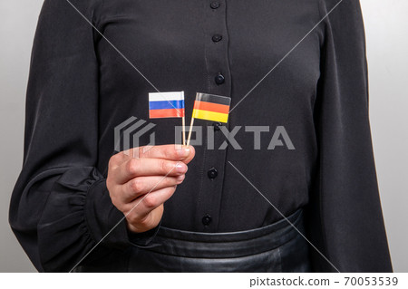German and Russian flags. Economic and political relations. Import and export. Gas exports and German and Russian flags. Economic and political relations. Import and export. Gas exports and 70053539