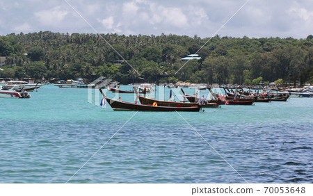 Idyllic crystal seawater in front of luxury hotel, parking boat on coastline backgrounds during holidays, wave from clear blue green sea and fine sand Phuket Thailand toursim advertisement Idyllic crystal seawater in front of luxury hotel, parking boat on coastline backgrounds during holidays, wave from clear blue green sea and fine sand Phuket Thailand toursim advertisement 70053648