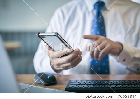 Men looking at smartphones Business at hand 70053884