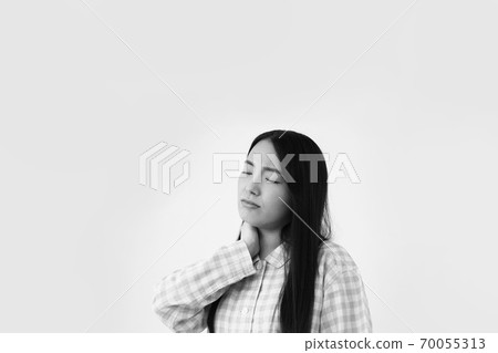 Image of a woman in pajamas who is not feeling well 70055313