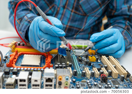 Technician repairing micro circuit main board computer electronic technology, hardware, mobile phone, upgrade, cleaning concept. Technician repairing micro circuit main board computer electronic technology, hardware, mobile phone, upgrade, cleaning concept. 70056303