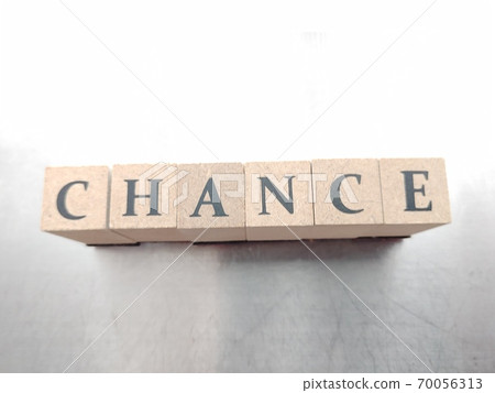 Dice letters lined up with CHANCE in bright light 70056313