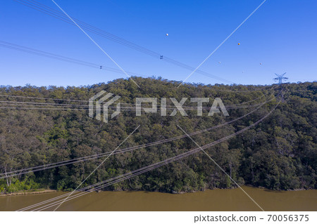An electricity transmission tower and cables across a river in regional New South Wales in Australia 70056375