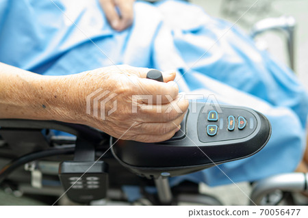 Asian senior or elderly old lady woman patient on electric wheelchair with remote control at nursing hospital ward, healthy strong medical concept 70056477