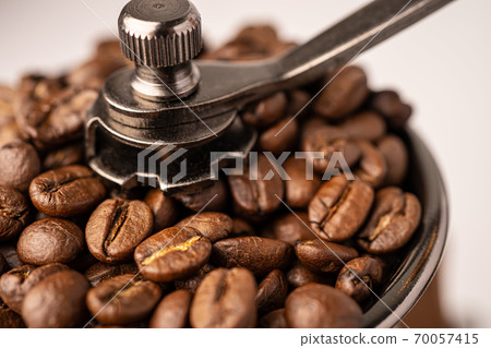 Coffee bean roasted in wooden grinder. Coffee bean roasted in wooden grinder. 70057415