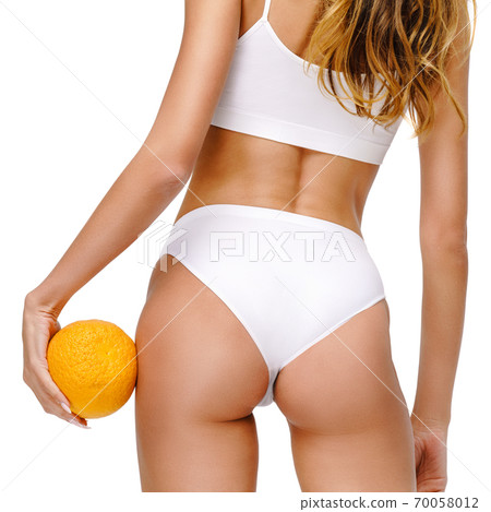 studio shot of attractive young woman with beautiful body holding orange isolated on white studio shot of attractive young woman with beautiful body holding orange isolated on white 70058012
