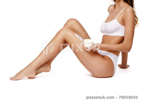 Beautiful Young Woman holding can of cream isolated on white background - Youth and Skin Care Concept 70058050