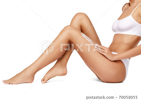 Slim woman's legs isolated on white background 70058055