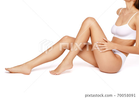 Slim woman's legs isolated on white background 70058091
