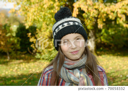 young pre teen with a winter cap, outdoors 70058332
