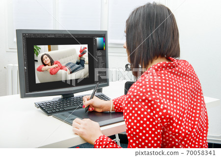 Young female designer using graphics tablet while Young female designer using graphics tablet while 70058341