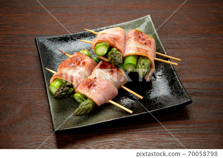 Skewed asparagus wrapped in bacon Skewed asparagus wrapped in bacon 70058798