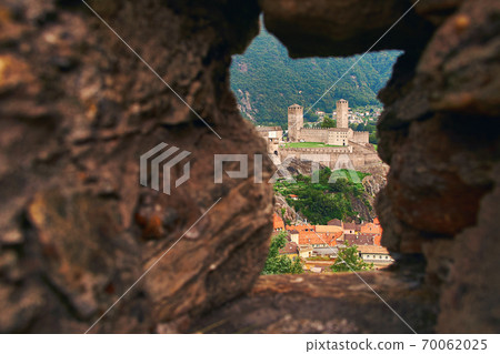 View of beautiful town of Bellinzona in Switzerland with Castelgrande from the stone wall of Montebello castle 70062025