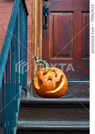 Carved Halloween pumpkins or jack o'lantern on the doorstep in Brooklyn Carved Halloween pumpkins or jack o'lantern on the doorstep in Brooklyn 70062628